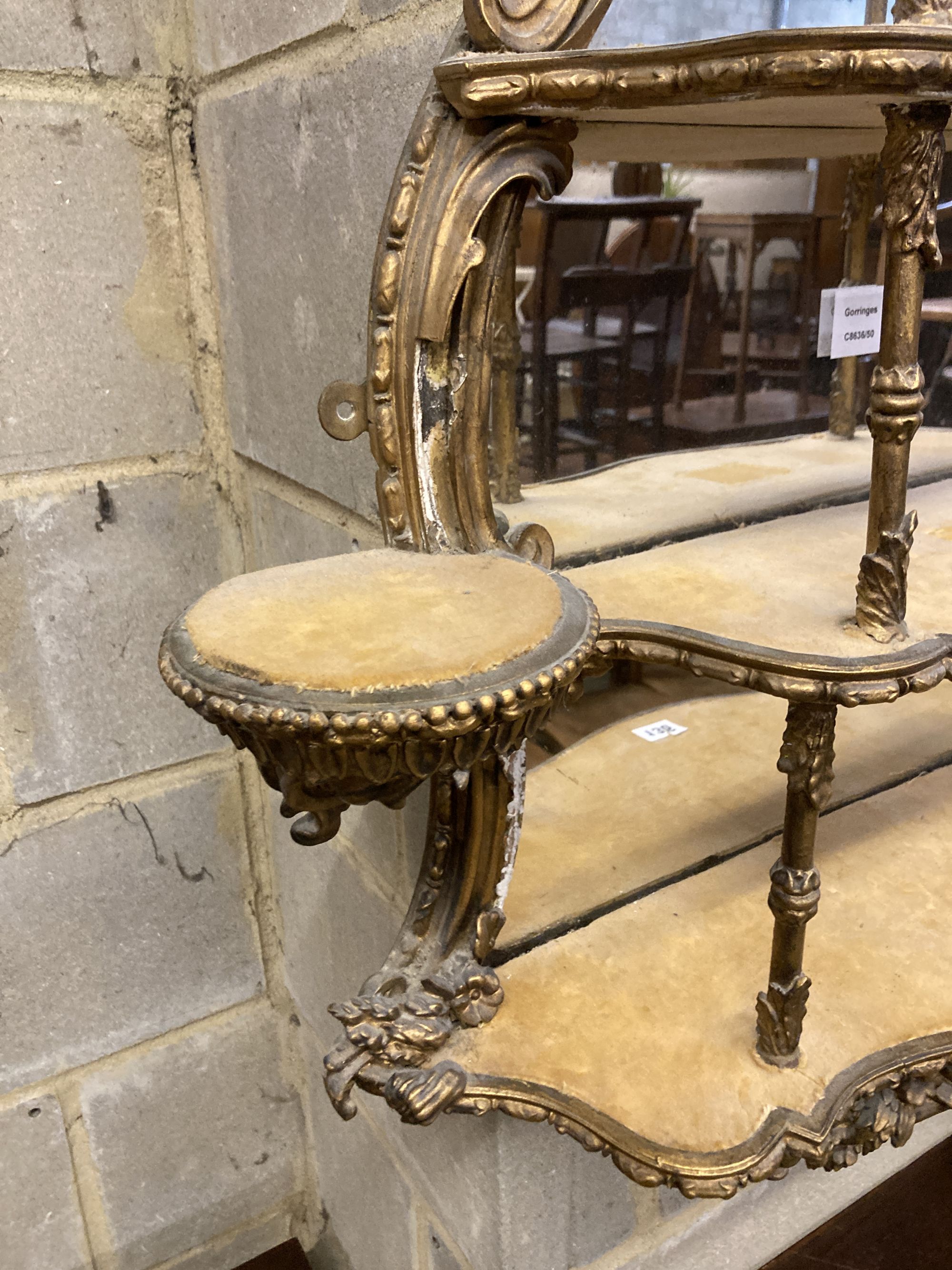 A Victorian gilt carved wood and gesso four tier mirrored bracket, width 70cm, depth 17cm, height 90cm